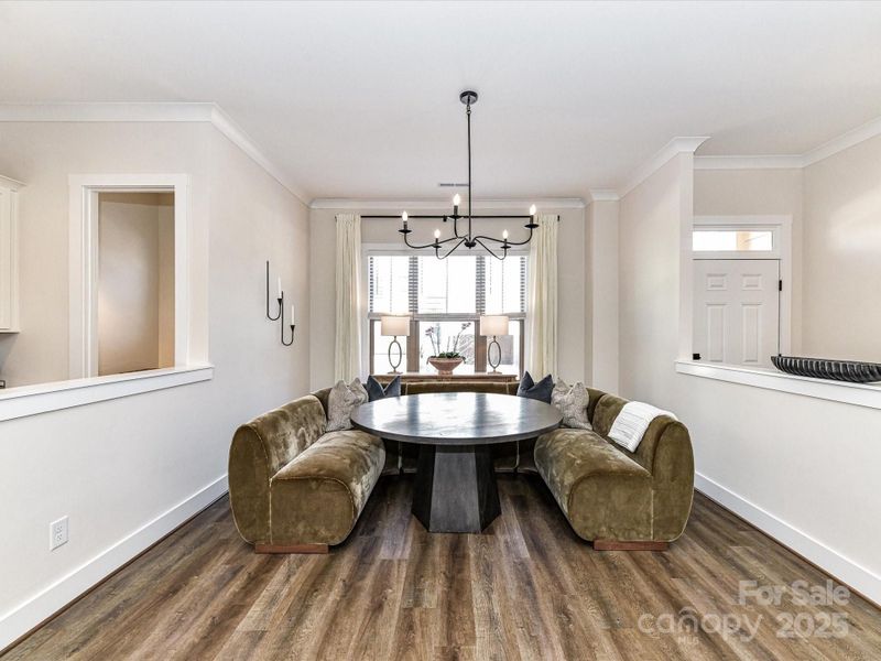 Spacious Dining Area with custom light fixture, plenty of natural light & LVP floors!