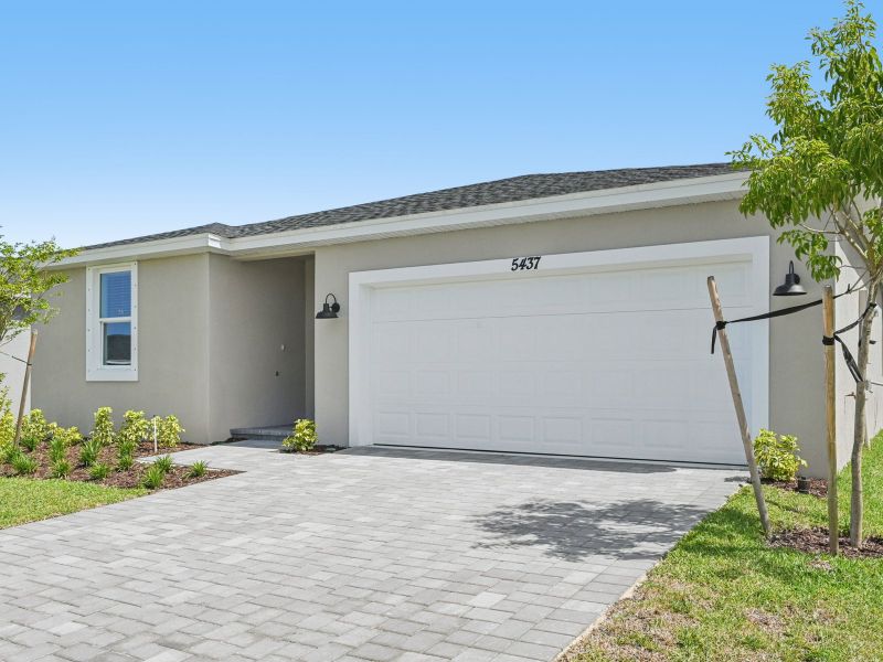 Front exterior of a new home in Hampton Park - Classic Series, Vero Beach, FL, highlighting curb appeal (Image 16). Front exterior of a new home in Hampton Park - Classic Series, Vero Beach, FL, highlighting curb appeal (Image 16).