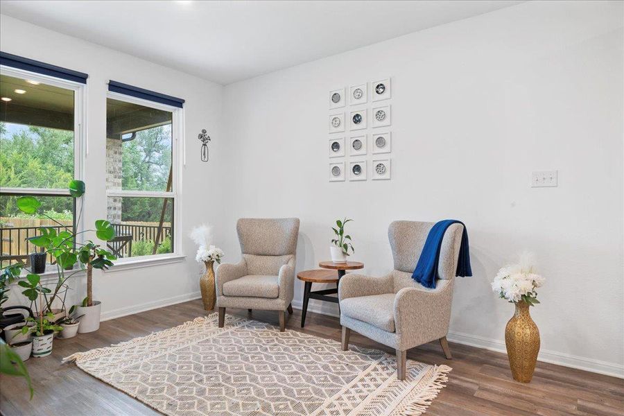 Living area featuring dark wood finished floors and baseboards