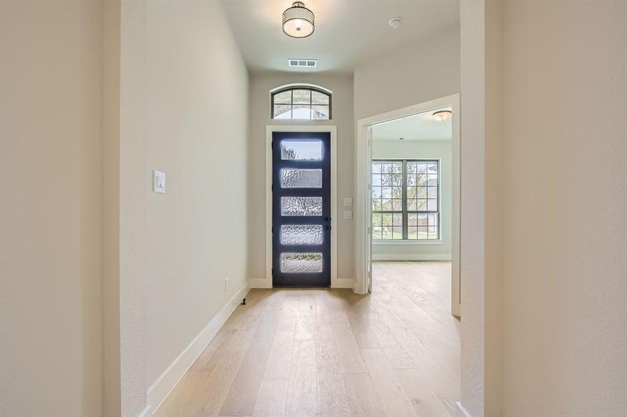 Entryway featuring light wood-type flooring and baseboards Entryway featuring light wood-type flooring and baseboards