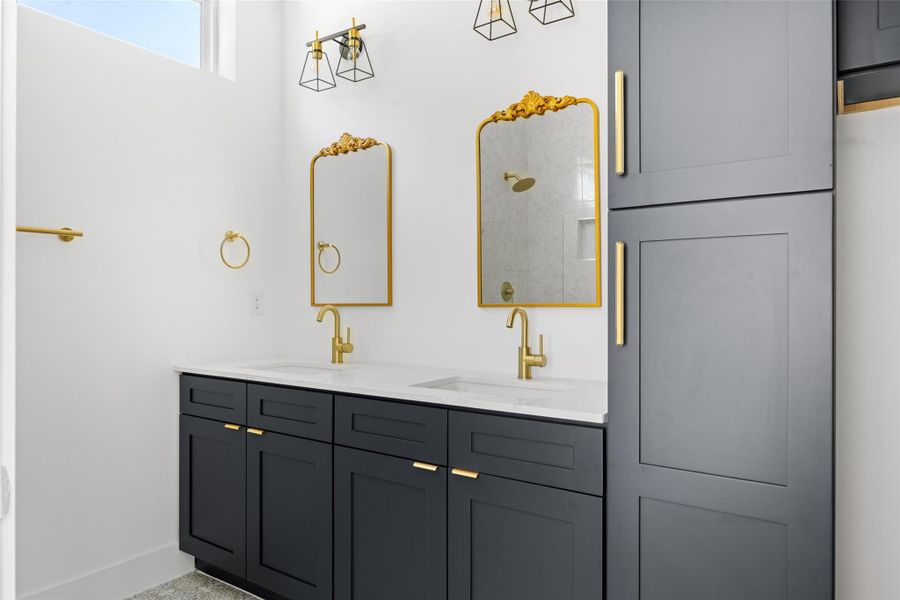 Full bathroom featuring double vanity and a tile shower Full bathroom featuring double vanity and a tile shower