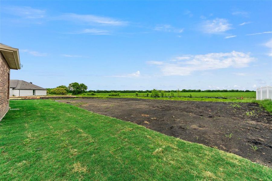 View of grassy yard with a rural view