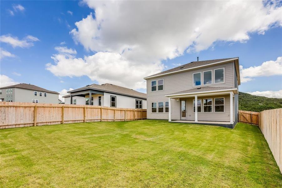 Imagine grilling out for friends and family in this generous backyard!