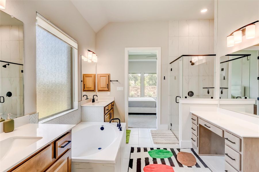 Luxurious bathroom features a soaking tub, dual vanities, and a spacious walk-in shower.