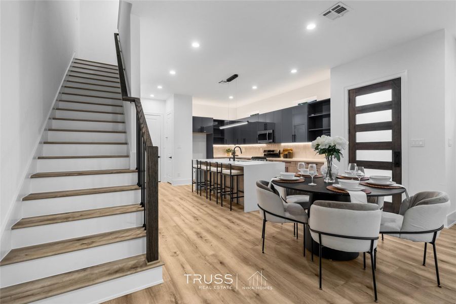 A sculptural focal point in its own right, the stairway pairs sleek black railings with warm toned treads to create a sense of upward rhythm and architectural grace. Every step reflects Nima Homes’ mastery of proportion and flow, where form becomes function and movement feels artfully designed.