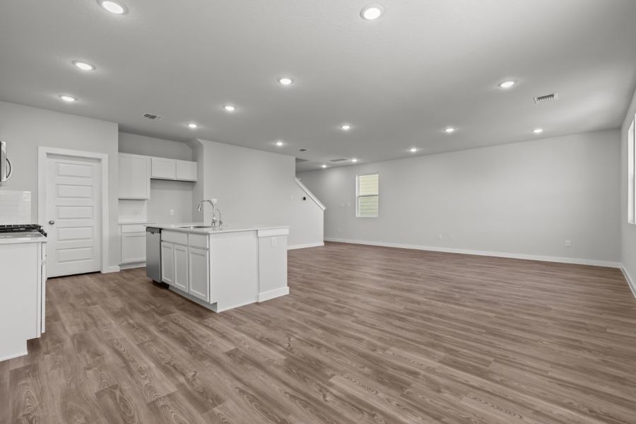 A large kitchen with white cabinets. A large kitchen with white cabinets.