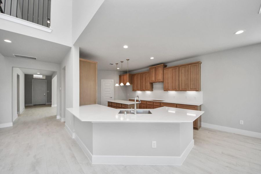 The kitchen is a culinary haven, featuring granite countertops, a tile backsplash, stainless steel appliances, 42” upper cabinets, and undercabinet lighting.