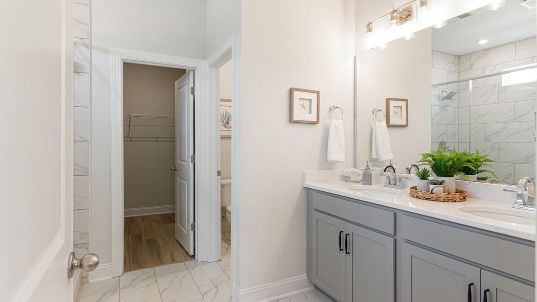 owner's suite bath with dual vanity, tile shower, and water closet owner's suite bath with dual vanity, tile shower, and water closet