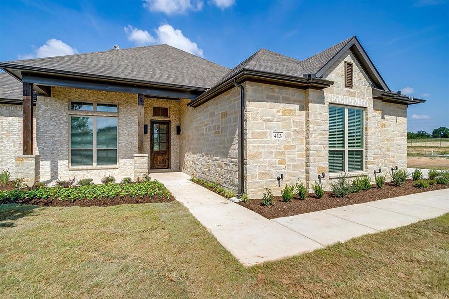 View of front of home featuring a front lawn