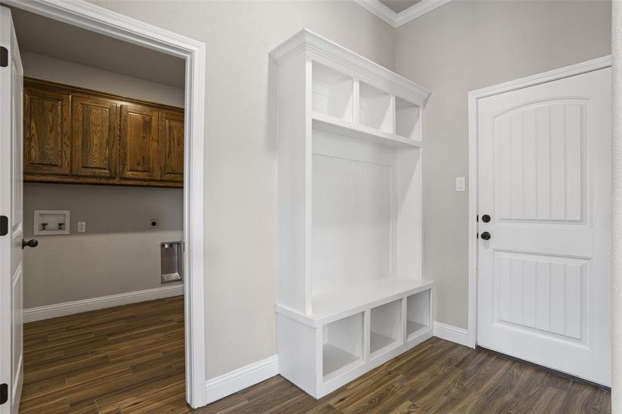 Mudroom with crown molding and dark hardwood / wood-style flooring