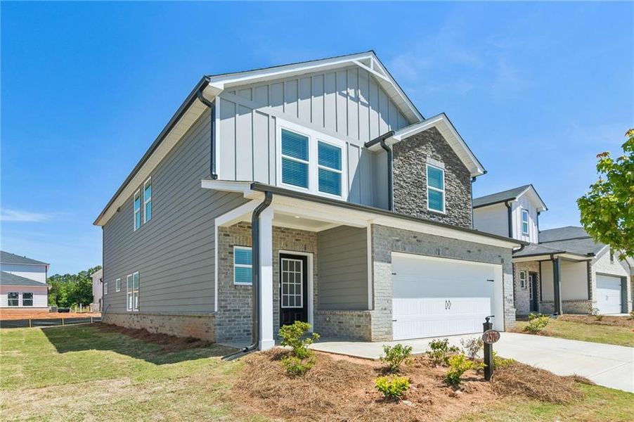 Front exterior of a new home in Martin Springs - Reserve Series, Lawrenceville, GA, highlighting curb appeal (Image 26). Front exterior of a new home in Martin Springs - Reserve Series, Lawrenceville, GA, highlighting curb appeal (Image 26).