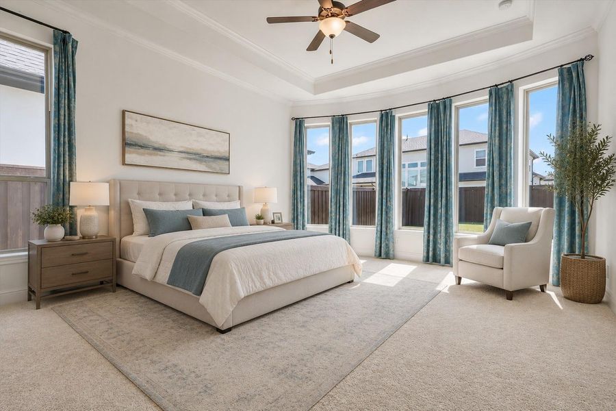 Your spacious primary bedroom features recessed ceiling and a bay style window, bringing ample natural light. This photo has been virtually staged to assist with viewers perspective.