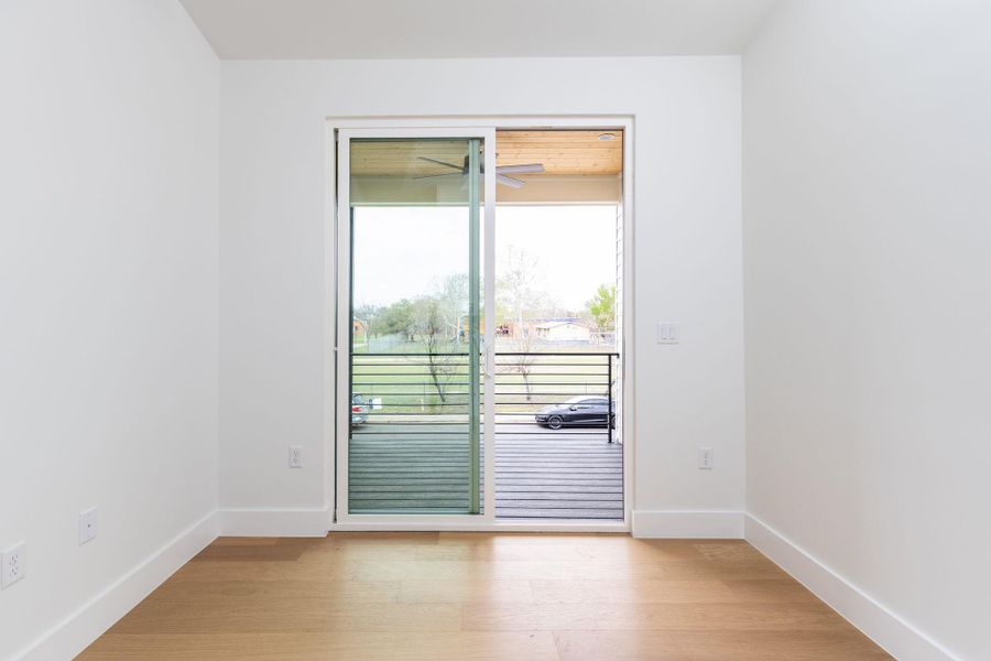 Unfurnished room featuring light wood-type flooring and baseboards