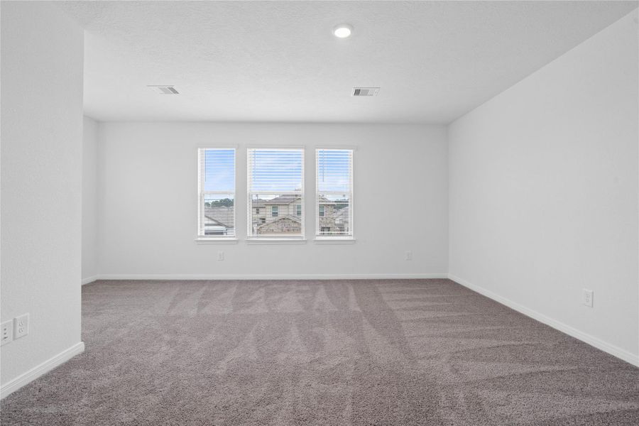 Relax and unwind after a long day in this impressive primary suite! This generously sized room offers plush carpeting, neutral-toned paint, high ceilings, recessed lighting, and large windows for added comfort and tranquility. Relax and unwind after a long day in this impressive primary suite! This generously sized room offers plush carpeting, neutral-toned paint, high ceilings, recessed lighting, and large windows for added comfort and tranquility.