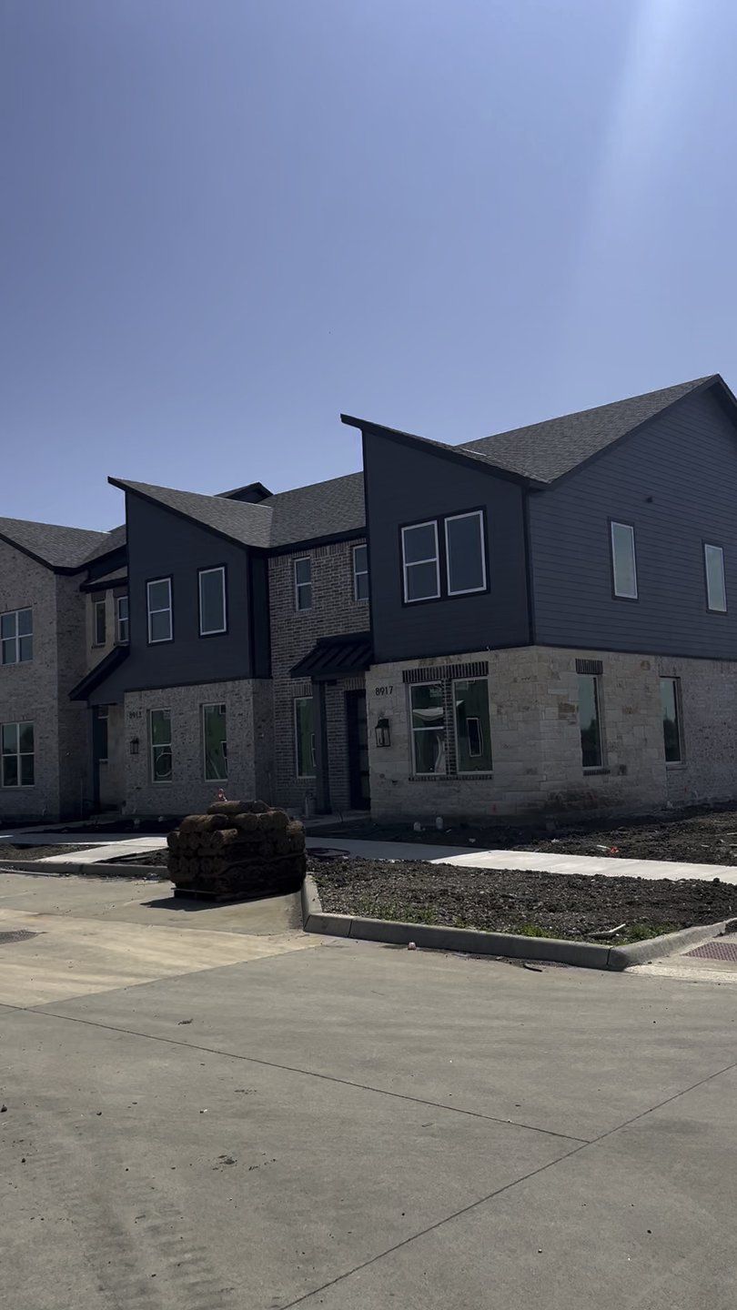 A contemporary gray duplex with stone accents in Rose Place by Aspen Square Homes (Frisco, TX). A contemporary gray duplex with stone accents in Rose Place by Aspen Square Homes (Frisco, TX).