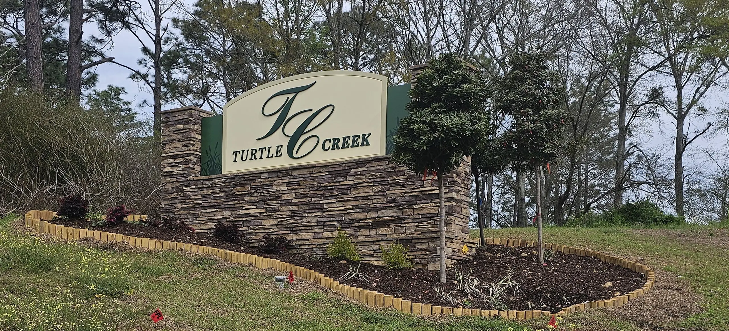Entrance to the Turtle Creek community in Cantonment, FL, featuring signage and landscaping (Image 1).