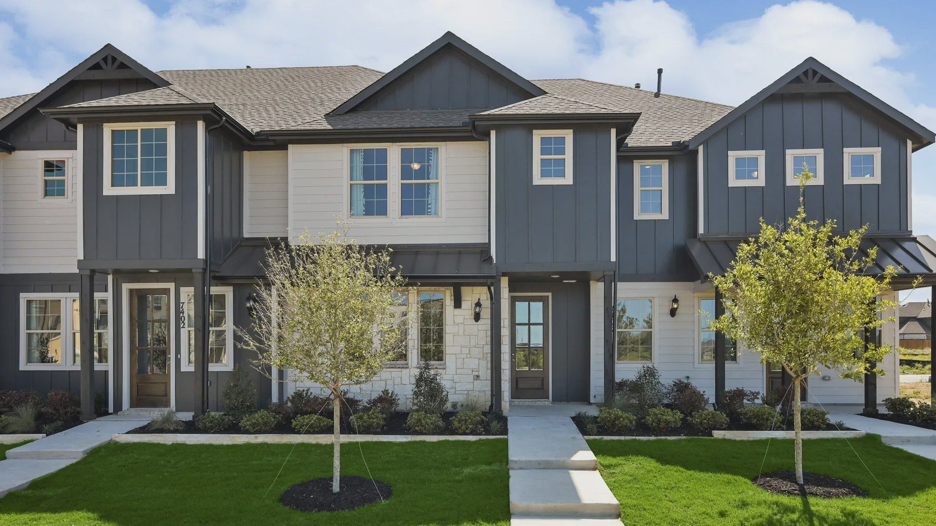 Luxurious townhouse in Hawkes Cove showcases sleek gray siding, elegant white trim, and expansive windows. Luxurious townhouse in Hawkes Cove showcases sleek gray siding, elegant white trim, and expansive windows.