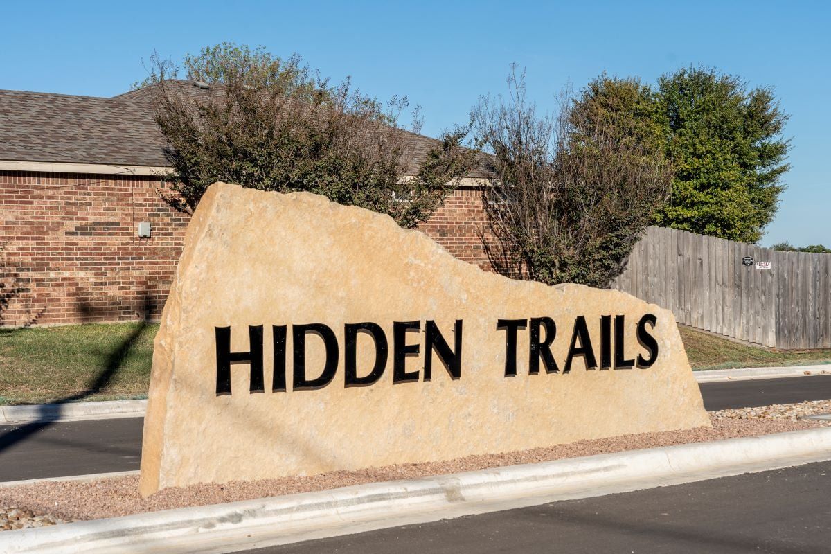 Entrance to the Hidden Trails community in Belton, TX, featuring signage and landscaping (Image 1).