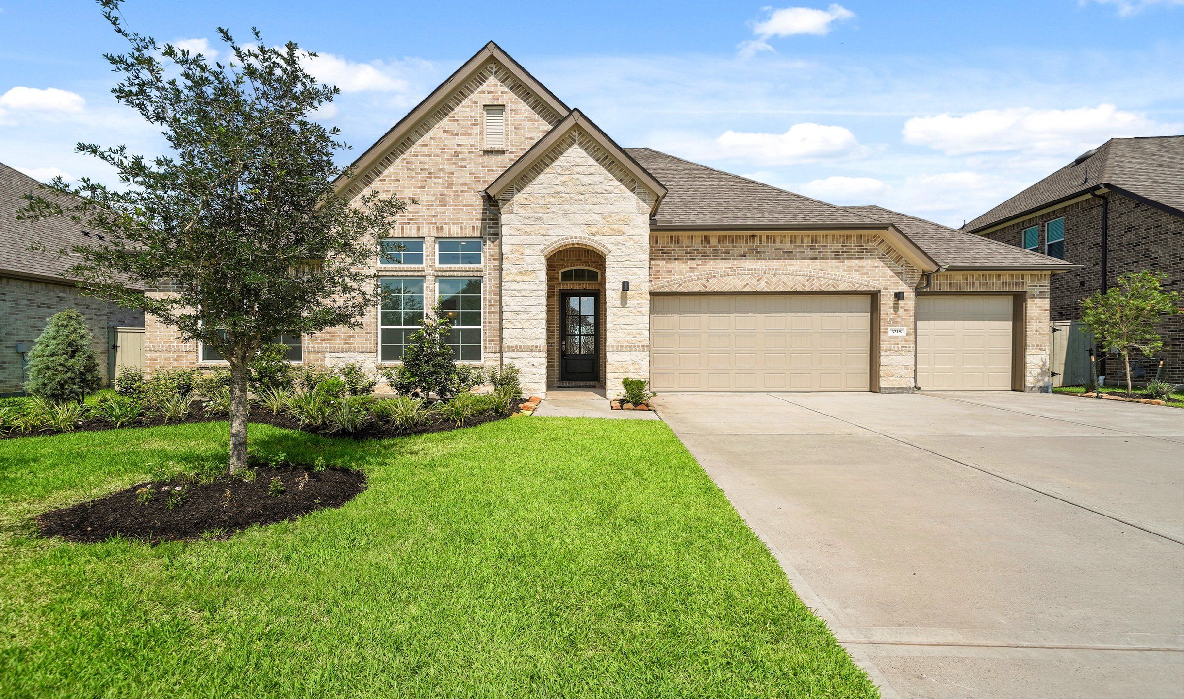 Front exterior of a home in the Grand Oaks community, located in Mont Belvieu, TX (Image 1).