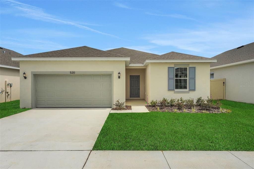 Front exterior of a new home in Cypress Park Estates, Haines City, FL, highlighting curb appeal (Image 1). Front exterior of a new home in Cypress Park Estates, Haines City, FL, highlighting curb appeal (Image 1).
