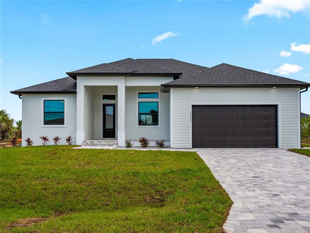 Front exterior of a new home in , Port Charlotte, FL, highlighting curb appeal (Image 1). Front exterior of a new home in , Port Charlotte, FL, highlighting curb appeal (Image 1).