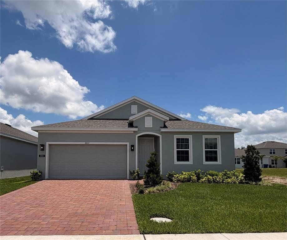 Front exterior of a new home in Trinity Place, St. Cloud, FL, highlighting curb appeal (Image 1). Front exterior of a new home in Trinity Place, St. Cloud, FL, highlighting curb appeal (Image 1).