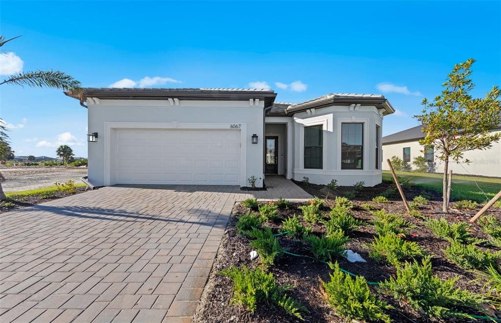 Front exterior of a new home in Talon Preserve on Palmer Ranch, Nokomis, FL, highlighting curb appeal (Image 1). Front exterior of a new home in Talon Preserve on Palmer Ranch, Nokomis, FL, highlighting curb appeal (Image 1).