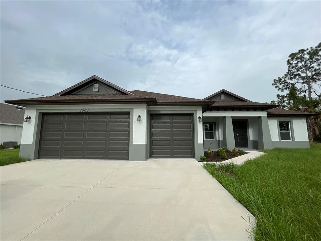 Front exterior of a new home in , North Port, FL, highlighting curb appeal (Image 1). Front exterior of a new home in , North Port, FL, highlighting curb appeal (Image 1).