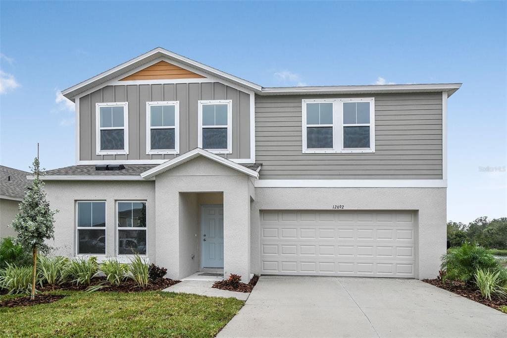 Front exterior of a new home in Scenic Terrace, Haines City, FL, highlighting curb appeal (Image 1).