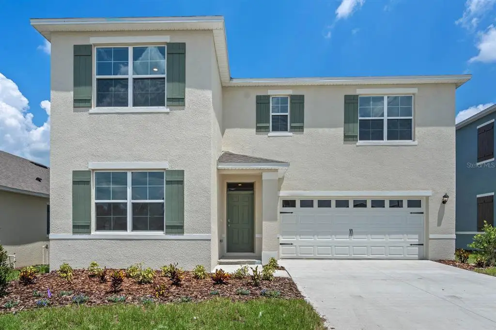 Front exterior of a new home in Timberwalk, Mount Dora, FL, highlighting curb appeal (Image 1). Front exterior of a new home in Timberwalk, Mount Dora, FL, highlighting curb appeal (Image 1).