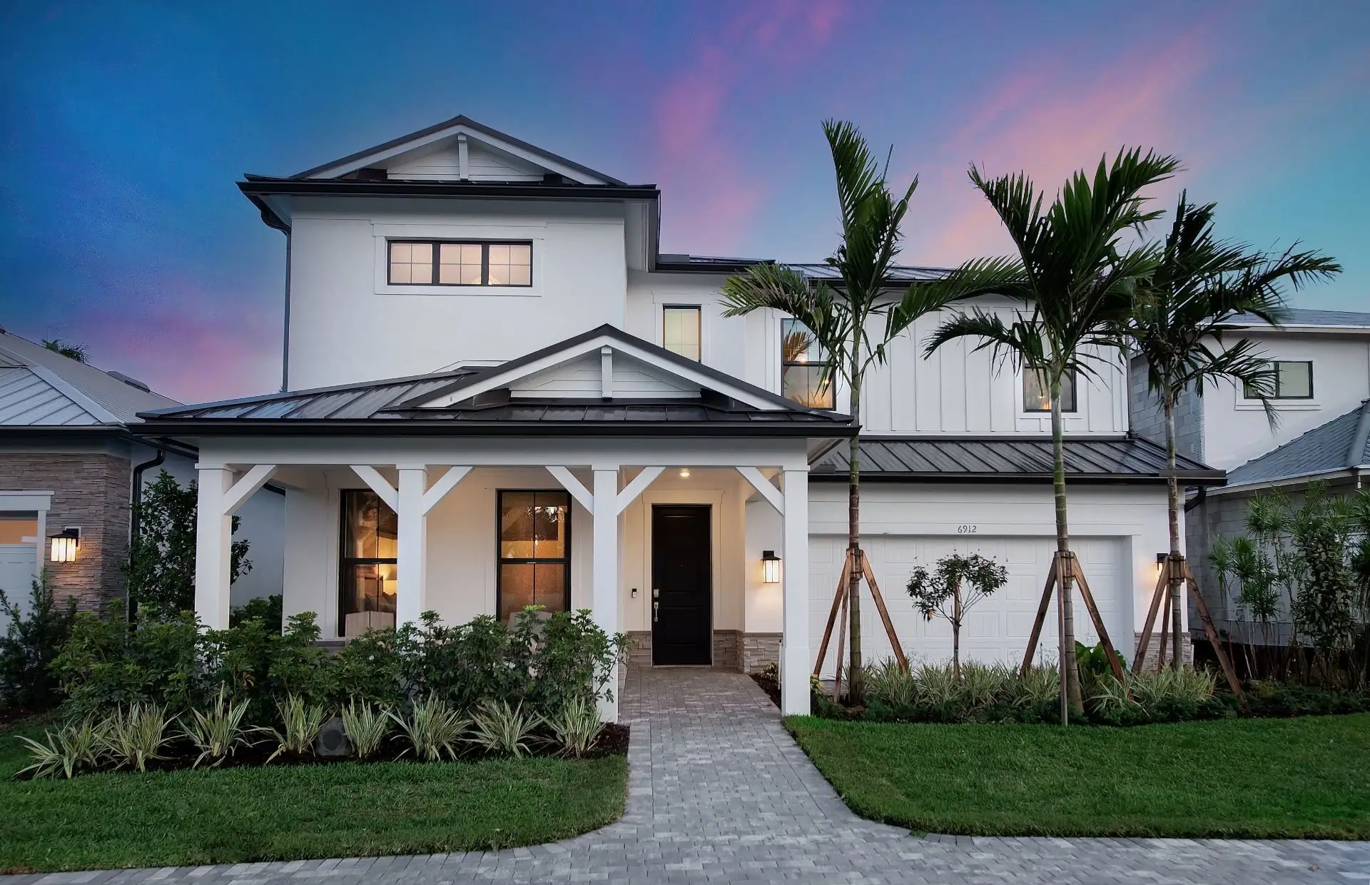 Front exterior of a new home in The Reserve at Eastpointe, Palm Beach Gardens, FL, highlighting curb appeal (Image 1). Front exterior of a new home in The Reserve at Eastpointe, Palm Beach Gardens, FL, highlighting curb appeal (Image 1).
