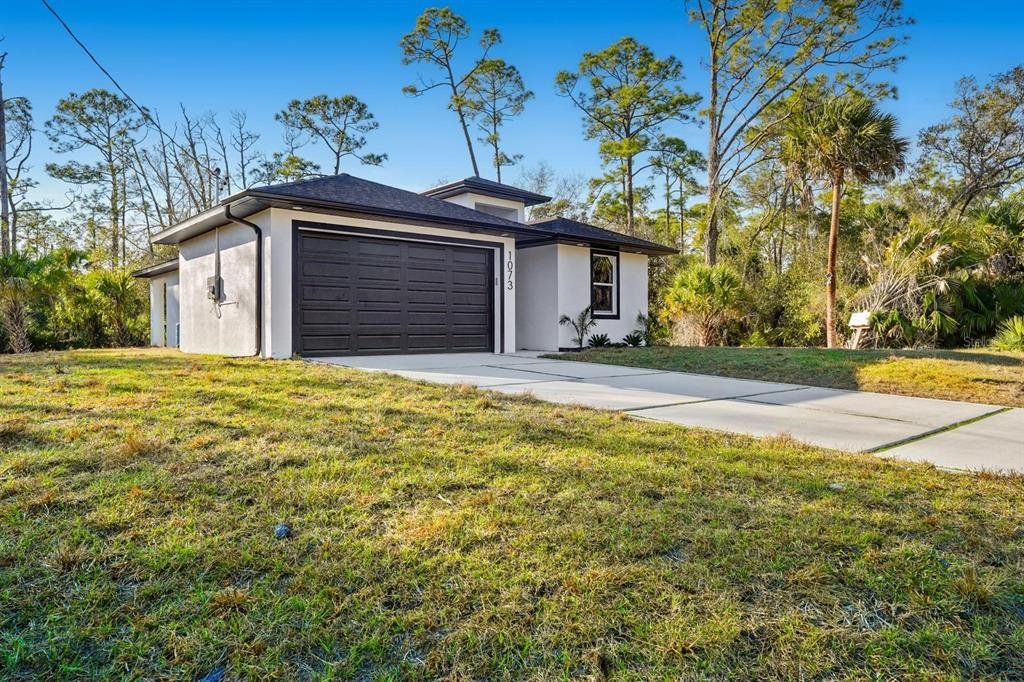 Front exterior of a new home in , Port Charlotte, FL, highlighting curb appeal (Image 1). Front exterior of a new home in , Port Charlotte, FL, highlighting curb appeal (Image 1).