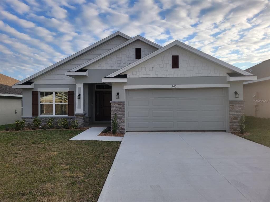Front exterior of a new home in Arbor Park, Leesburg, FL, highlighting curb appeal (Image 1). Front exterior of a new home in Arbor Park, Leesburg, FL, highlighting curb appeal (Image 1).