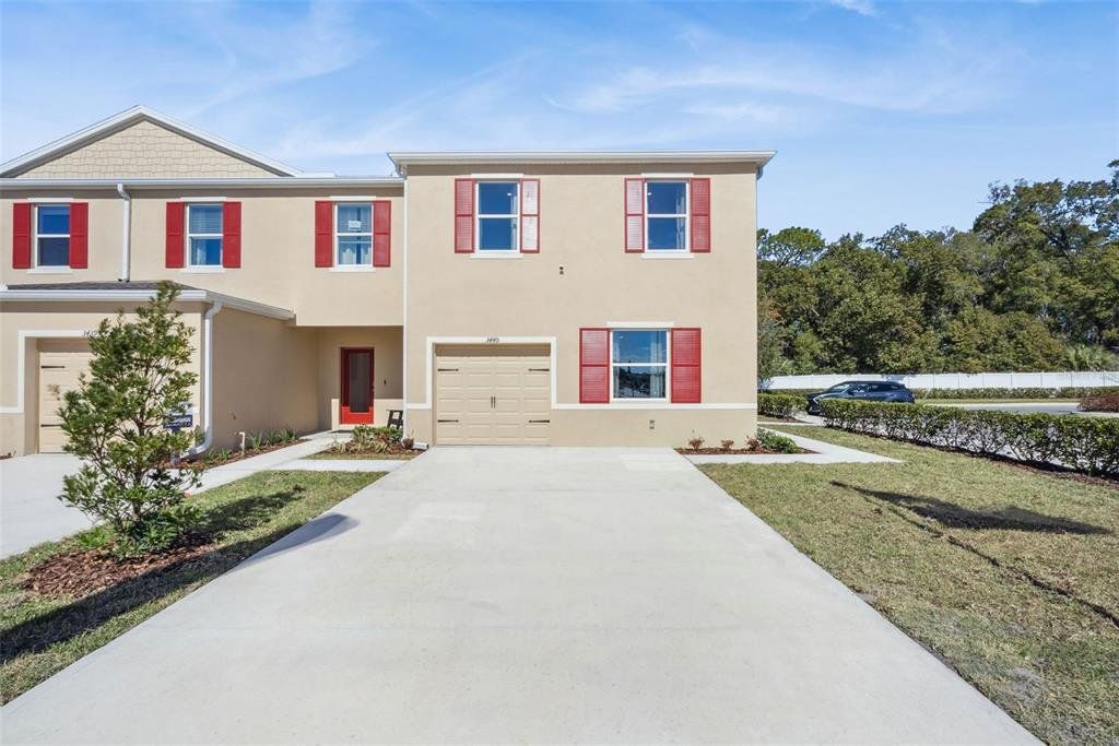 Front exterior of a new home in Oak Pointe, Apopka, FL, highlighting curb appeal (Image 1). Front exterior of a new home in Oak Pointe, Apopka, FL, highlighting curb appeal (Image 1).