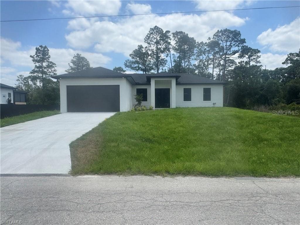 Front exterior of a new home in , Lehigh Acres, FL, highlighting curb appeal (Image 1). Front exterior of a new home in , Lehigh Acres, FL, highlighting curb appeal (Image 1).