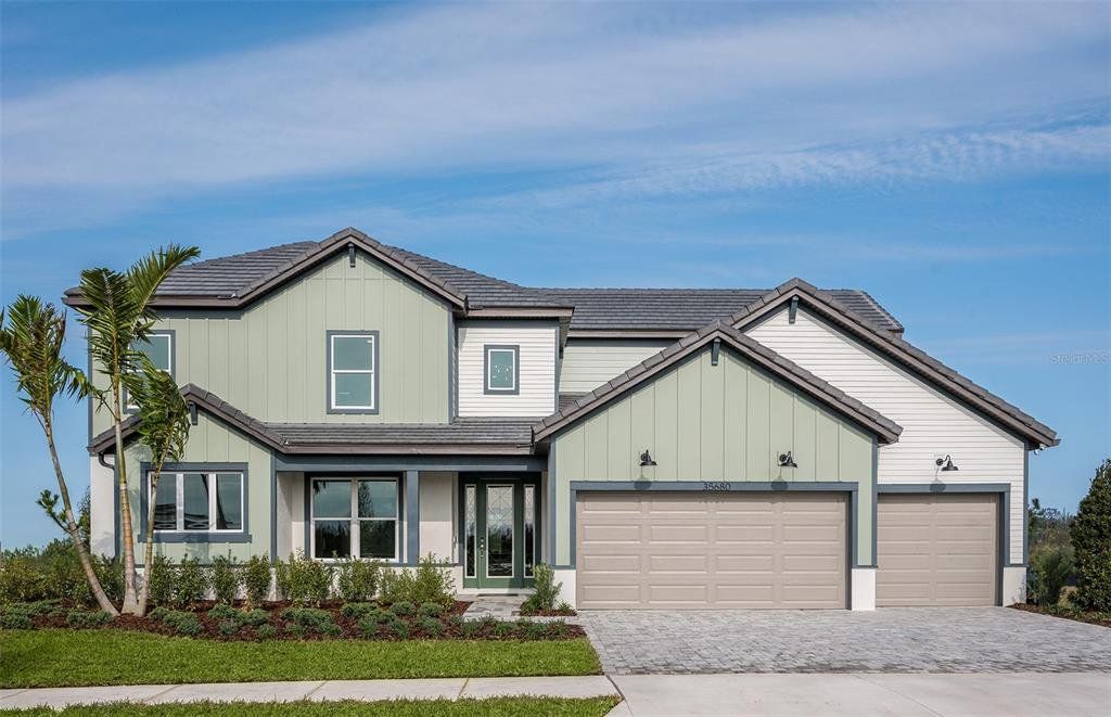 Front exterior of a new home in Two Rivers, Zephyrhills, FL, highlighting curb appeal (Image 1). Front exterior of a new home in Two Rivers, Zephyrhills, FL, highlighting curb appeal (Image 1).