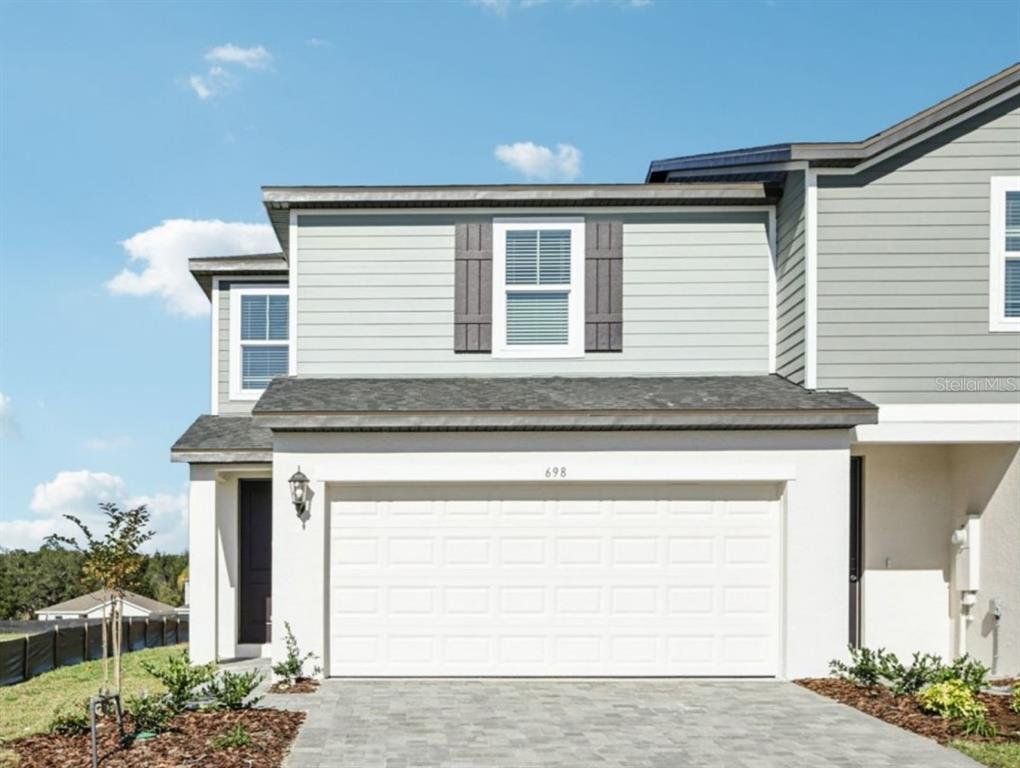 Front exterior of a new home in , Lady Lake, FL, highlighting curb appeal (Image 1). Front exterior of a new home in , Lady Lake, FL, highlighting curb appeal (Image 1).