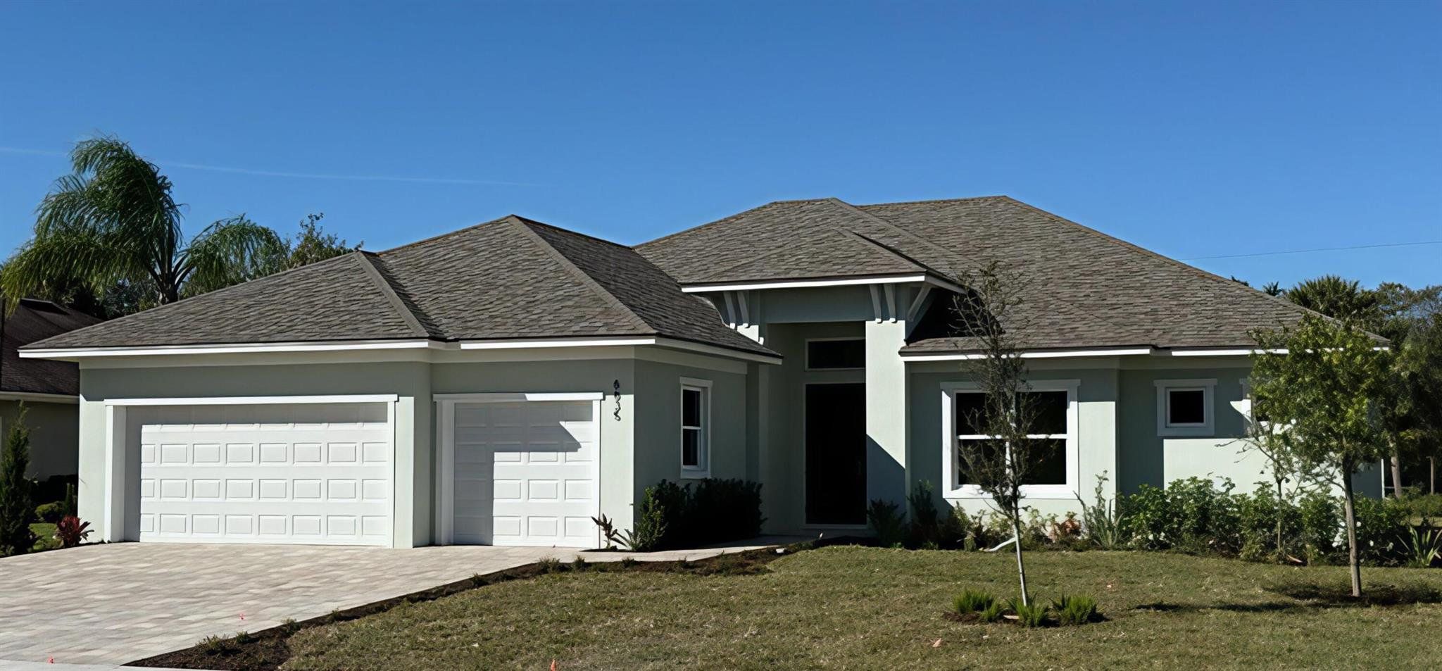 Front exterior of a new home in , Vero Beach, FL, highlighting curb appeal (Image 1).
