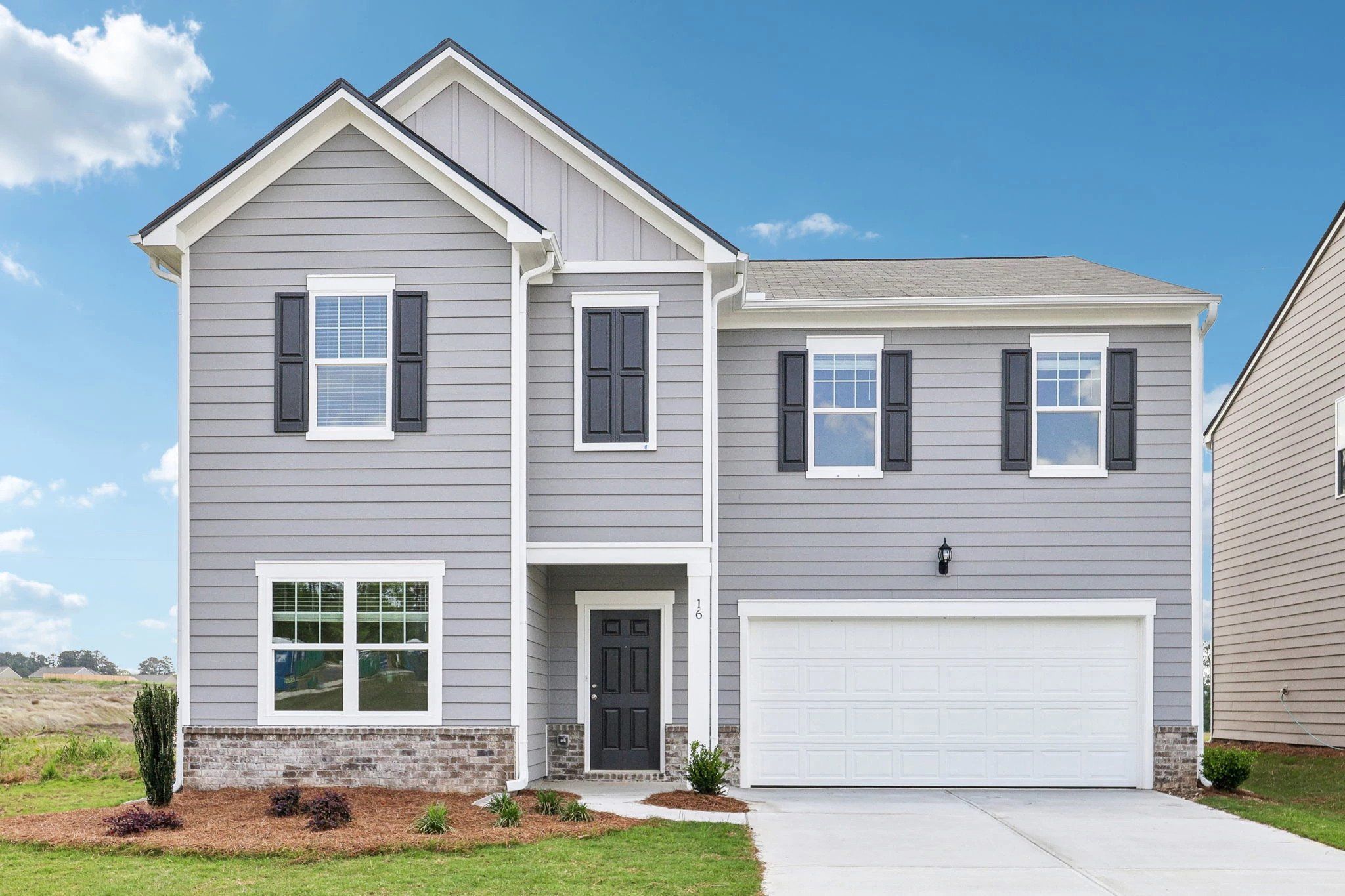 Front exterior of a new home in Mt. Tabor Ridge, Dallas, GA, highlighting curb appeal (Image 1). Front exterior of a new home in Mt. Tabor Ridge, Dallas, GA, highlighting curb appeal (Image 1).