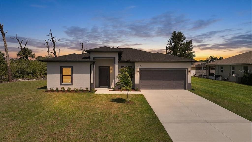 Front exterior of a new home in , Port Charlotte, FL, highlighting curb appeal (Image 1). Front exterior of a new home in , Port Charlotte, FL, highlighting curb appeal (Image 1).
