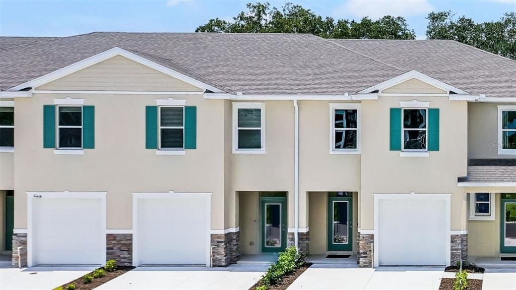 Front exterior of a new home in Nona West, Orlando, FL, highlighting curb appeal (Image 1). Front exterior of a new home in Nona West, Orlando, FL, highlighting curb appeal (Image 1).