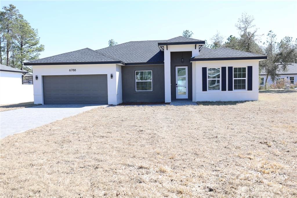 Front exterior of a new home in , Ocala, FL, highlighting curb appeal (Image 1). Front exterior of a new home in , Ocala, FL, highlighting curb appeal (Image 1).