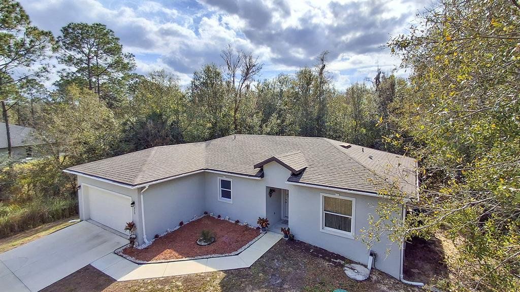 Front exterior of a new home in , Poinciana, FL, highlighting curb appeal (Image 1). Front exterior of a new home in , Poinciana, FL, highlighting curb appeal (Image 1).
