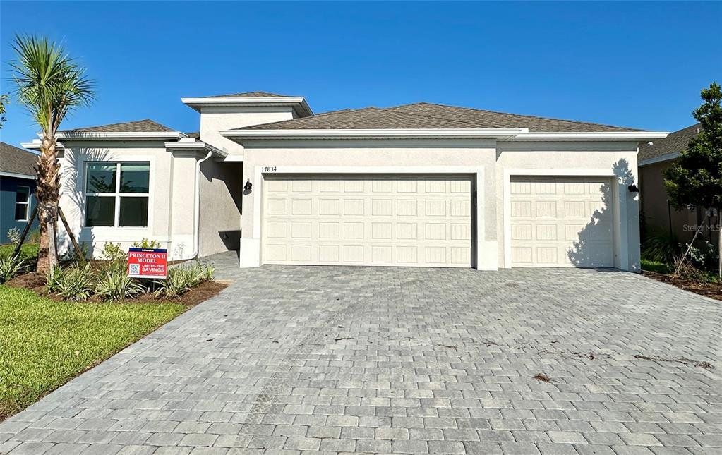 Front exterior of a new home in Rye Ranch: Manor Homes, Parrish, FL, highlighting curb appeal (Image 1).
