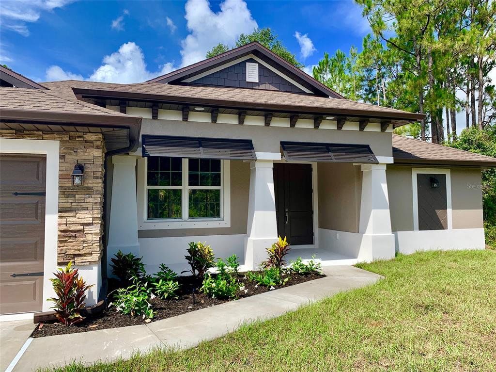 Front exterior of a new home in , North Port, FL, highlighting curb appeal (Image 1). Front exterior of a new home in , North Port, FL, highlighting curb appeal (Image 1).
