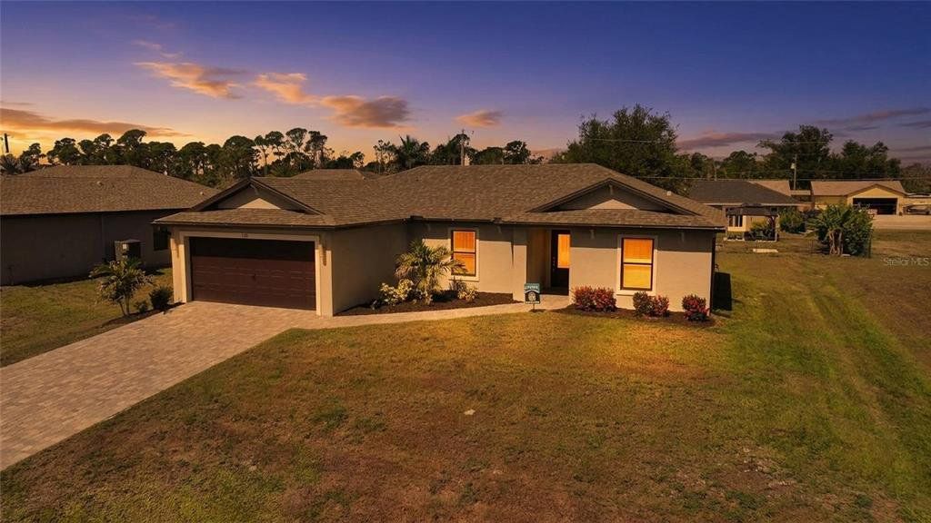 Front exterior of a new home in , Port Charlotte, FL, highlighting curb appeal (Image 1). Front exterior of a new home in , Port Charlotte, FL, highlighting curb appeal (Image 1).