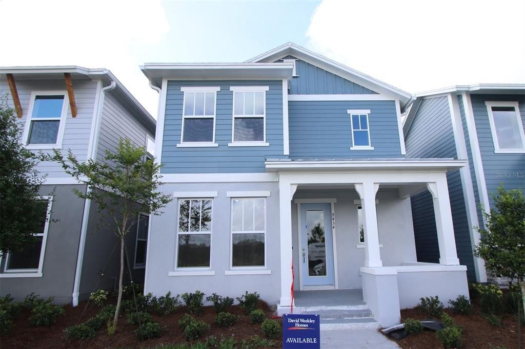 Front exterior of a new home in Laureate Park at Lake Nona - Garden Series, Orlando, FL, highlighting curb appeal (Image 1). Front exterior of a new home in Laureate Park at Lake Nona - Garden Series, Orlando, FL, highlighting curb appeal (Image 1).