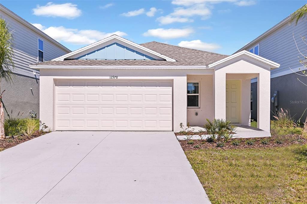 Front exterior of a new home in Villa Mar, Winter Haven, FL, highlighting curb appeal (Image 1).