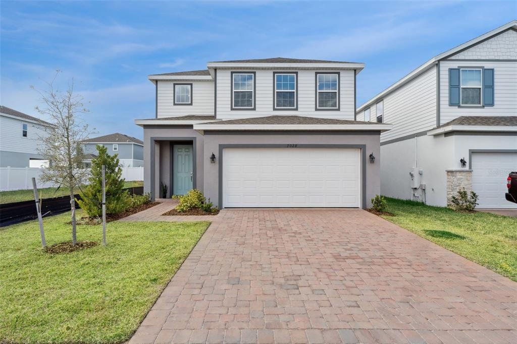 Front exterior of a new home in Trinity Lakes, Groveland, FL, highlighting curb appeal (Image 1). Front exterior of a new home in Trinity Lakes, Groveland, FL, highlighting curb appeal (Image 1).