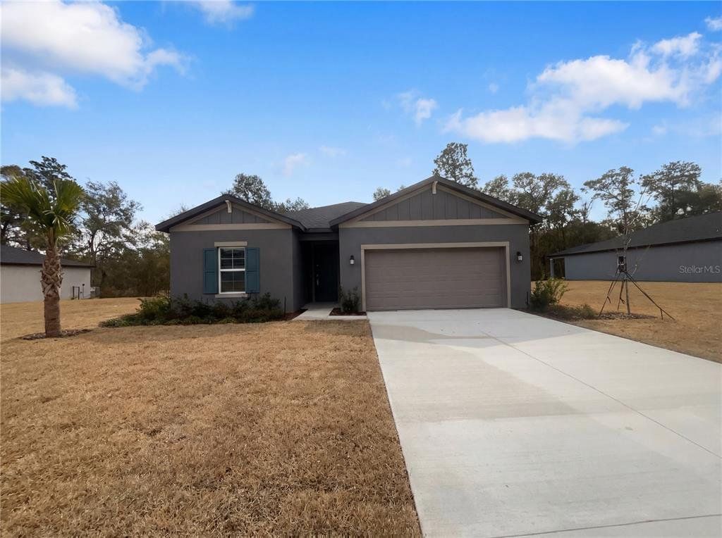 Front exterior of a new home in Grand Park, Dunnellon, FL, highlighting curb appeal (Image 1). Front exterior of a new home in Grand Park, Dunnellon, FL, highlighting curb appeal (Image 1).